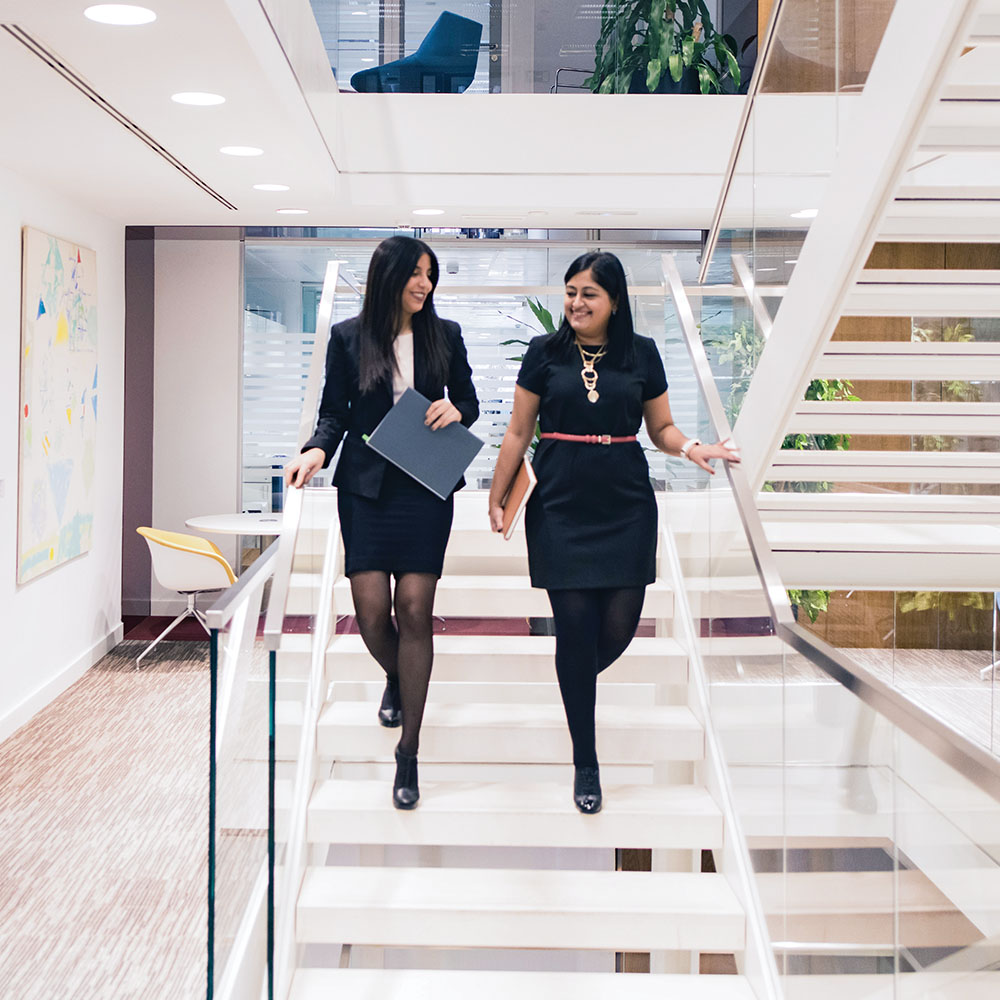 2 women walking down stairs