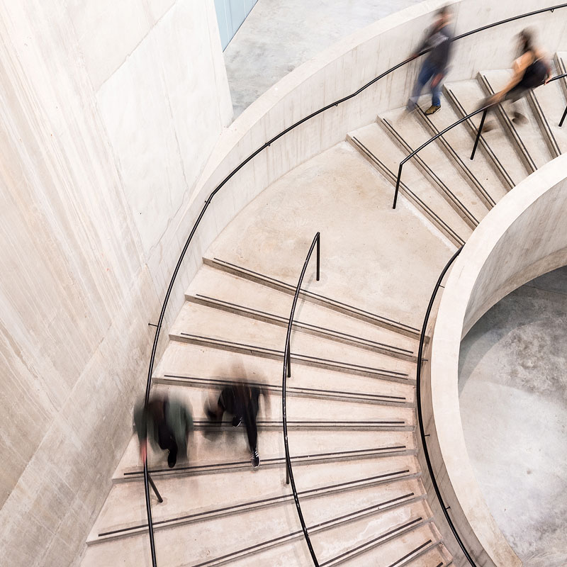 people going down a spiral staircase
