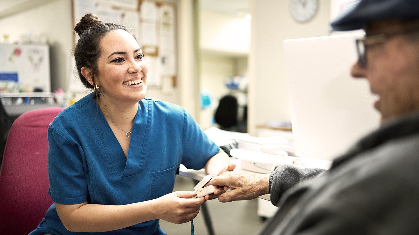 nurse interacting with patient banner
