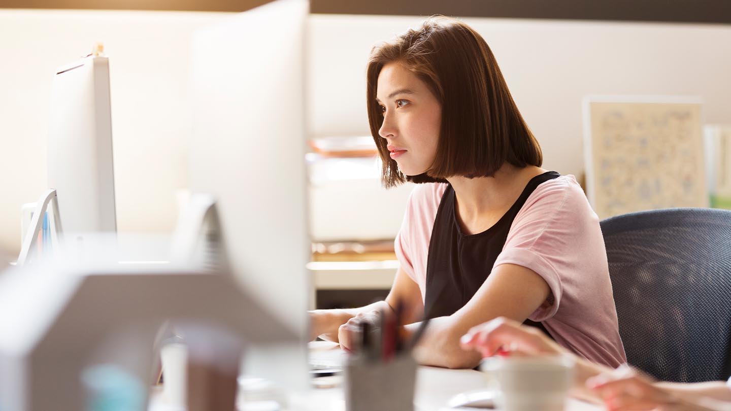 woman using her computer at office banner