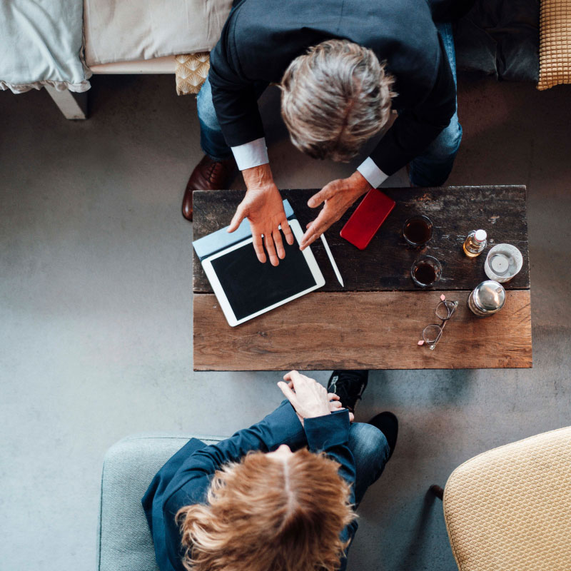 two people using an ipad. 