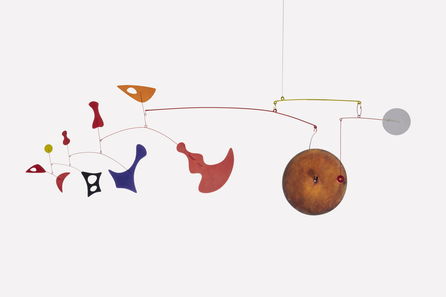 A colorful abstract mobile sculpture by Alexander Calder, featuring various shapes suspended in balance.