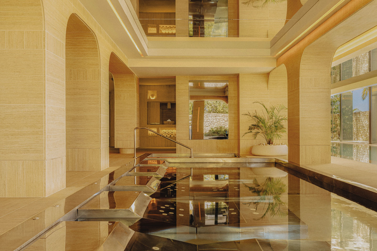 An indoor spa pool with modern architecture and natural light.