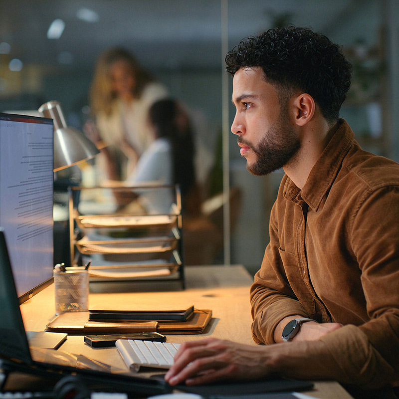 man using computer on his desk