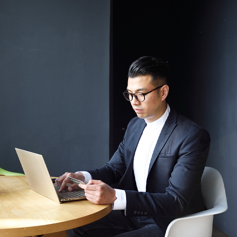 Man using credit card on laptop
